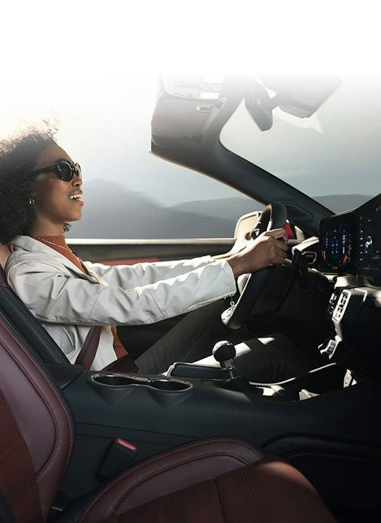 Person sitting in the driver’s seat of a 2024 Ford Mustang® convertible | Ed Morse Ford Red Bud in Red Bud IL